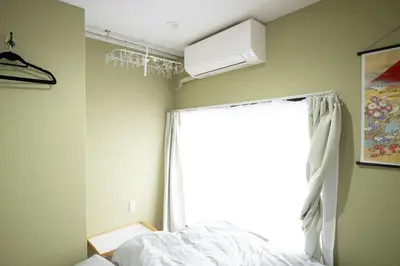 a bedroom with a bed and a window at VillaŌyama 111 in Tokyo