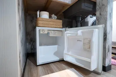 a refrigerator with its door open in a kitchen at VillaŌyama 111 in Tokyo