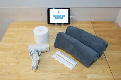 a table with a blanket and a computer on a floor at VillaŌyama 111 in Tokyo