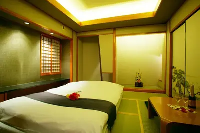 a bedroom with a bed with a flower on it at \u30db\u30c6\u30eb \u30b0\u30ea\u30fc\u30f3\u30d2\u30ebAdult only in Tokyo
