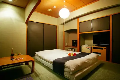 a bedroom with a bed and a table and a tv at \u30db\u30c6\u30eb \u30b0\u30ea\u30fc\u30f3\u30d2\u30ebAdult only in Tokyo