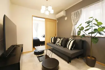 a living room with a couch and a table at Cozy house Tokyo in Tokyo