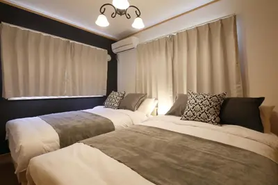 two beds in a bedroom with a window at Cozy house Tokyo in Tokyo