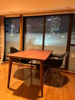 a wooden table and two chairs in front of a window at staytokyo1107 ONE bedroom in Tokyo