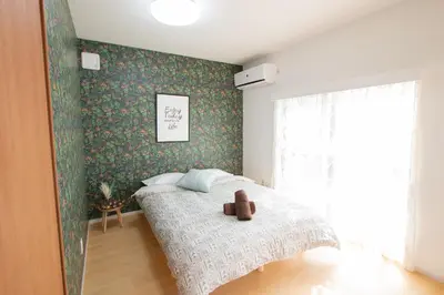 a bedroom with a bed with a teddy bear on it at Ikebukuro# Nakaitabashi 3DK room# 5 minutes walk from station in Tokyo