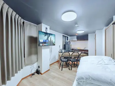 a room with a bed and a table and chairs at Hamanoya Main in Tokyo