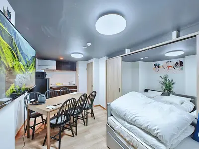 a bedroom with a bed and a table and chairs at Hamanoya Main in Tokyo