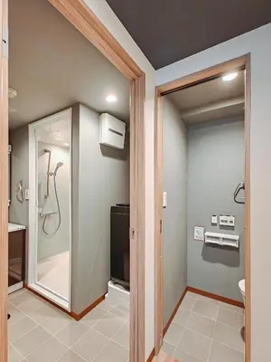 a bathroom with a walk in shower and a glass door at Hamanoya Main in Tokyo