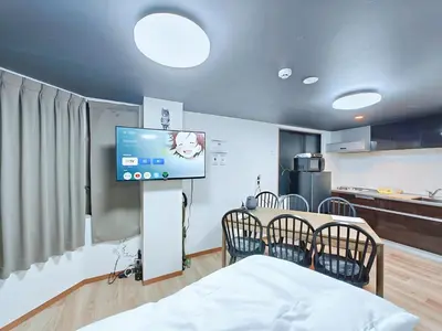 a room with a tv and a table and chairs at Hamanoya Main in Tokyo