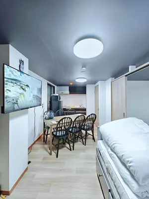 a room with a bed and a table and chairs at Hamanoya Main in Tokyo