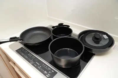 a group of pans sitting on top of a stove at NY House 2\u65b0\u5bbf\u4e09\u968e\u5efa\u30663\u5ba42\u30b7\u30e3\u30ef\u30fc2\u30c8\u30a4\u30ec in Tokyo