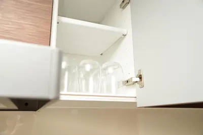a row of clear glasses in a kitchen cabinet at NY House 2\u65b0\u5bbf\u4e09\u968e\u5efa\u30663\u5ba42\u30b7\u30e3\u30ef\u30fc2\u30c8\u30a4\u30ec in Tokyo