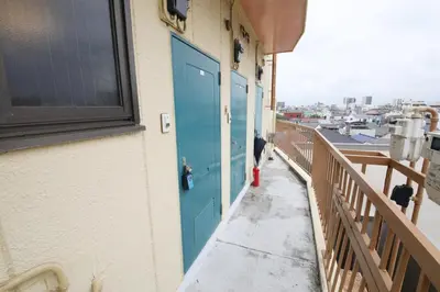 a blue door on a building with a balcony at Shitamachi Skyroom in Yotsugi Private Room in Tokyo
