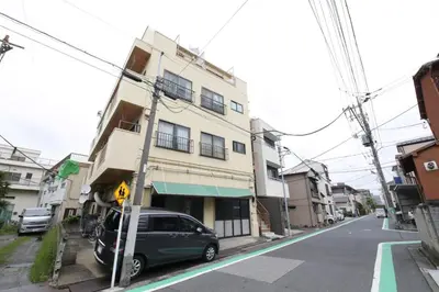 a green van parked in front of a building at Shitamachi Skyroom in Yotsugi Private Room in Tokyo