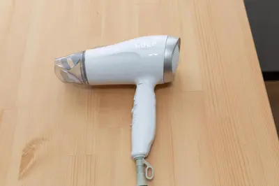 a hair dryer sitting on top of a wooden table at Tanuki Apartment Shinjuku West in Tokyo