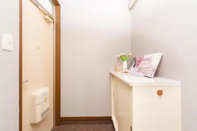 a bathroom with a counter with flowers on it at Tanuki Apartment Shinjuku West in Tokyo