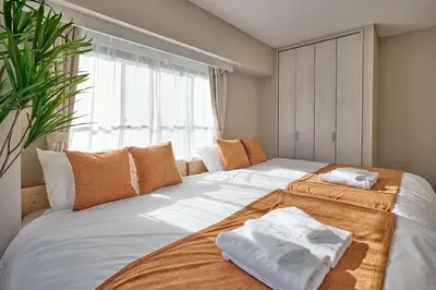 a bedroom with a large bed with towels on it at JR Itabashi 1min walk 4BR Ikebukuro 1, Shinjuku 2, Shibuya 3 in Tokyo