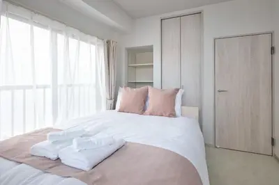 a bedroom with a large bed with towels on it at JR Itabashi 1min walk 4BR Ikebukuro 1, Shinjuku 2, Shibuya 3 in Tokyo