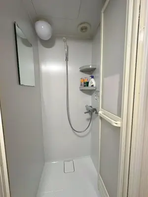a small bathroom with a shower and a toilet at \u6d45\u8349 \u30b9\u30ab\u30a4\u30c4\u30ea\u30fc\u570f10\u5206 \u4ea4\u901a\u81f3\u4fbf \u6d45\u8349\u5bfa\u89b3\u5149 \u53cc\u9b5a\u306e\u5bbf \u6771\u5411\u5cf61 in Tokyo