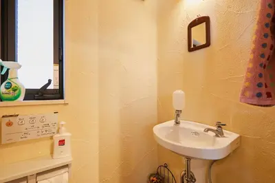 a small bathroom with a sink and a mirror at Dreamy Music Cafe Bar in Tokyo