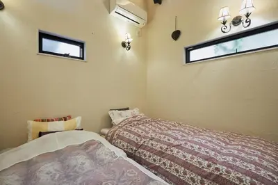 a bedroom with two beds and a window at Dreamy Music Cafe Bar in Tokyo