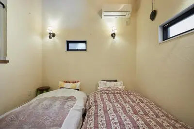 a small room with a bed and a window at Dreamy Music Cafe Bar in Tokyo