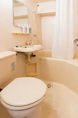 a bathroom with a toilet and a sink and a tub at Oji Inn \u738b\u5b50\u30a4\u30f3 in Tokyo