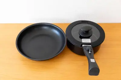 a black pan and a spatula on a table at Oji Inn \u738b\u5b50\u30a4\u30f3 in Tokyo
