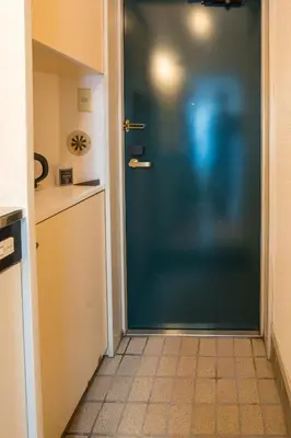 a blue door in a kitchen with a tile floor at Oji Inn \u738b\u5b50\u30a4\u30f3 in Tokyo