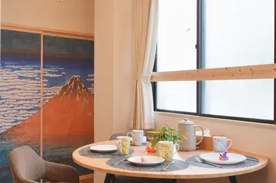 a dining room table with plates and cups on it at Mari Hotel in Tokyo