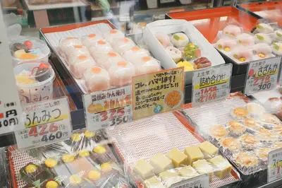 a display case in a store filled with food at Mari Hotel in Tokyo