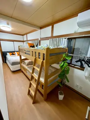 a room with two bunk beds and a potted plant at AiES \u5317\u5343\u4f4f \u5317\u5343\u4f4f\u7ad9\u8d708\u5206 \u76f4\u8fbe\u6674\u7a7a\u5854Asakusa\u79cb\u53f6\u539f\u4e0a\u91ce\u4e1c\u4eac\u94f6\u5ea7\u516d\u672c\u6728\u6d89\u8c37 \u6700\u592713\u4eba 100\u5e73\u65b9\u6237\u5efa5\u5ba49\u5e8a in Tokyo
