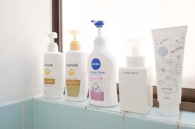a group of four bottles of moisturizers sitting on a counter at SAKURA villa \uff21166 in Tokyo
