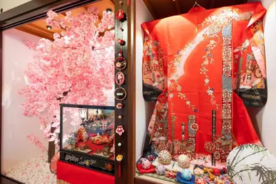a display case with a red dress and a tree at SAKURA villa \uff21166 in Tokyo