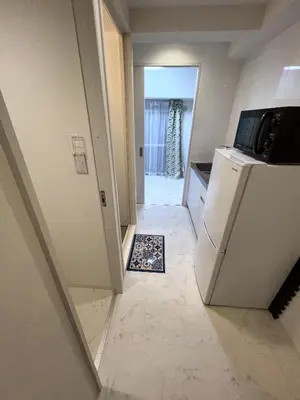 a kitchen with a refrigerator and a tile floor at \u6d45\u8349\u6c11\u6cca301 in Tokyo