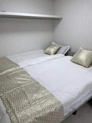 a bedroom with two beds with white sheets and pillows at \u6d45\u8349\u6c11\u6cca301 in Tokyo