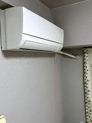 a white air conditioner hanging from a ceiling at \u6d45\u8349\u6c11\u6cca303 in Tokyo
