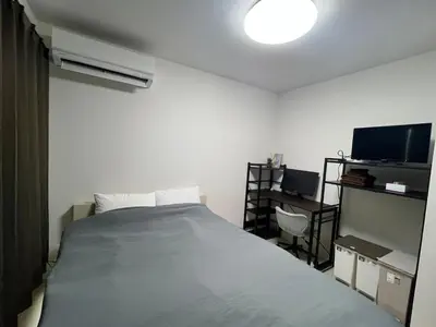 a bedroom with a large bed and a tv at Apartment Hotel in Katsushika City in Tokyo