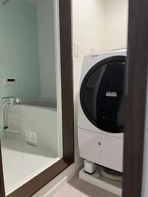 a microwave oven sitting next to a mirror at Apartment Hotel in Katsushika City in Tokyo