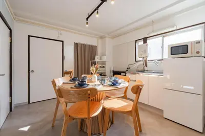 a kitchen and dining room with a table and chairs at HouseHotel\u4e94\u53cd\u7530 in Tokyo