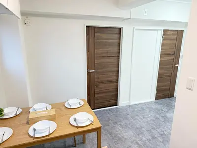 a dining room with a wooden table with plates on it at Shinjuku Area 5F Shinjuku Apartment No elevator in Tokyo