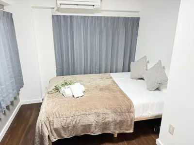a bedroom with a bed with two towels on it at Shinjuku Area 5F Shinjuku Apartment No elevator in Tokyo