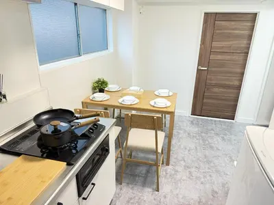 a kitchen with a stove and a small table at Shinjuku Area 5F Shinjuku Apartment No elevator in Tokyo