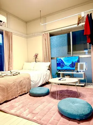a bedroom with a bed and a tv and a table at Retro Showa Home 9min from station Direct to Narita Near Disney Bus 48mim in Tokyo