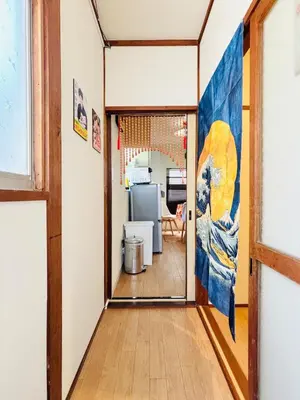 a hallway with a large painting on the wall at Retro Showa Home 9min from station Direct to Narita Near Disney Bus 48mim in Tokyo