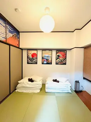 two beds in a room with pictures on the wall at 1min from station Hokusai and 2F nice view 2DK 30min from Tokyo station convenience store 30sec onsen 10min Haneda 55min in Tokyo