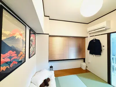 a living room with a window and a room with a bed at 1min from station Hokusai and 2F nice view 2DK 30min from Tokyo station convenience store 30sec onsen 10min Haneda 55min in Tokyo