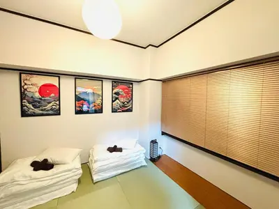a room with two beds and some pictures on the wall at 1min from station Hokusai and 2F nice view 2DK 30min from Tokyo station convenience store 30sec onsen 10min Haneda 55min in Tokyo