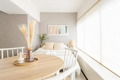 a dining room with a table and two beds at Good access to Shinjuku! Japandi Style Room in Nakano, Tokyo - Podhouse Nakano in Tokyo