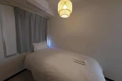 a bedroom with a white bed and a chandelier at Good access to Shinjuku! Japandi Style Room in Nakano, Tokyo - Podhouse Nakano in Tokyo
